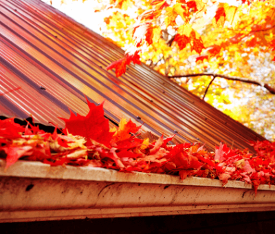 autumn leaves filling gutters on home gutter clean required